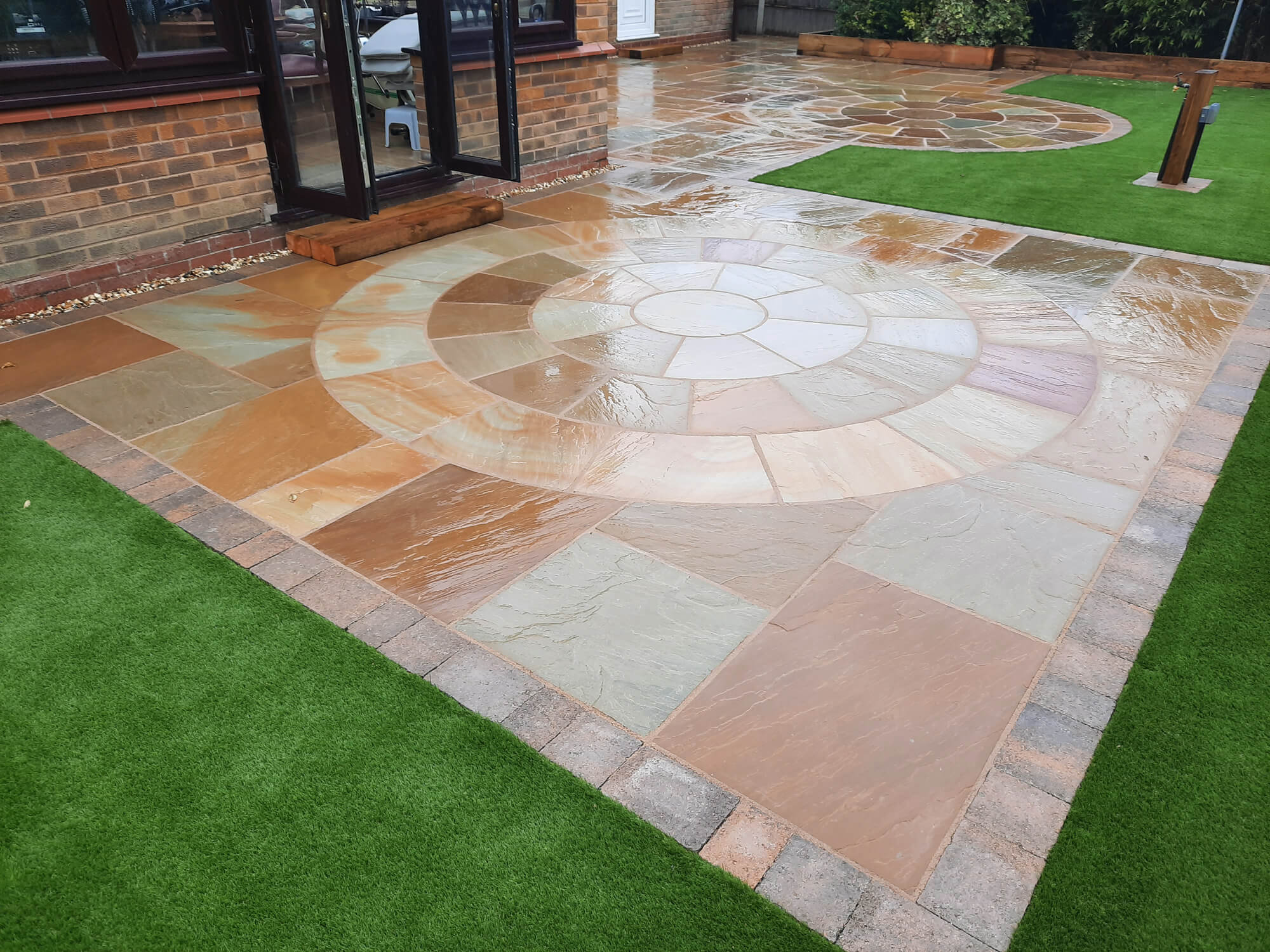 Artificial Grass installation with a Sandstone patio