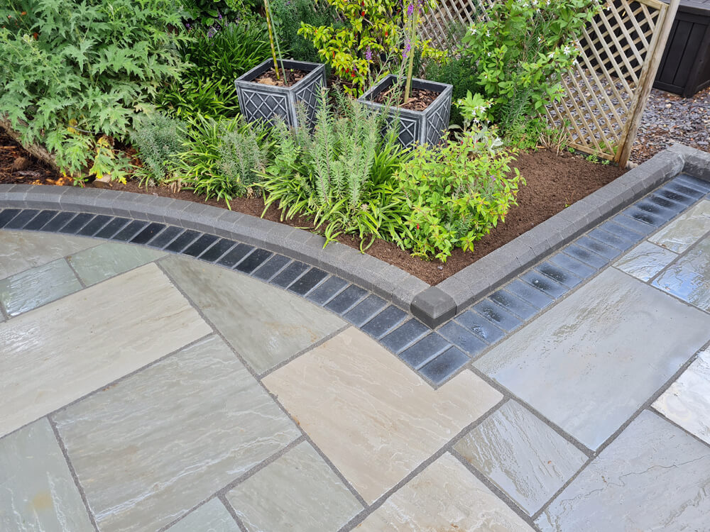 Case Study Grey Sandstone Slabs with Charcoal Block Paving Border Nuneaton